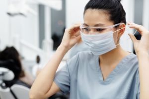 Nurse putting on face mask